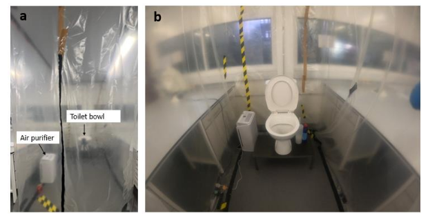 a toilet and air purifier inside a small room that has been sealed inside with plastic